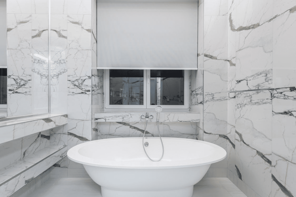 White Ceramic Bathtub In White Patterned Wall Tiles
