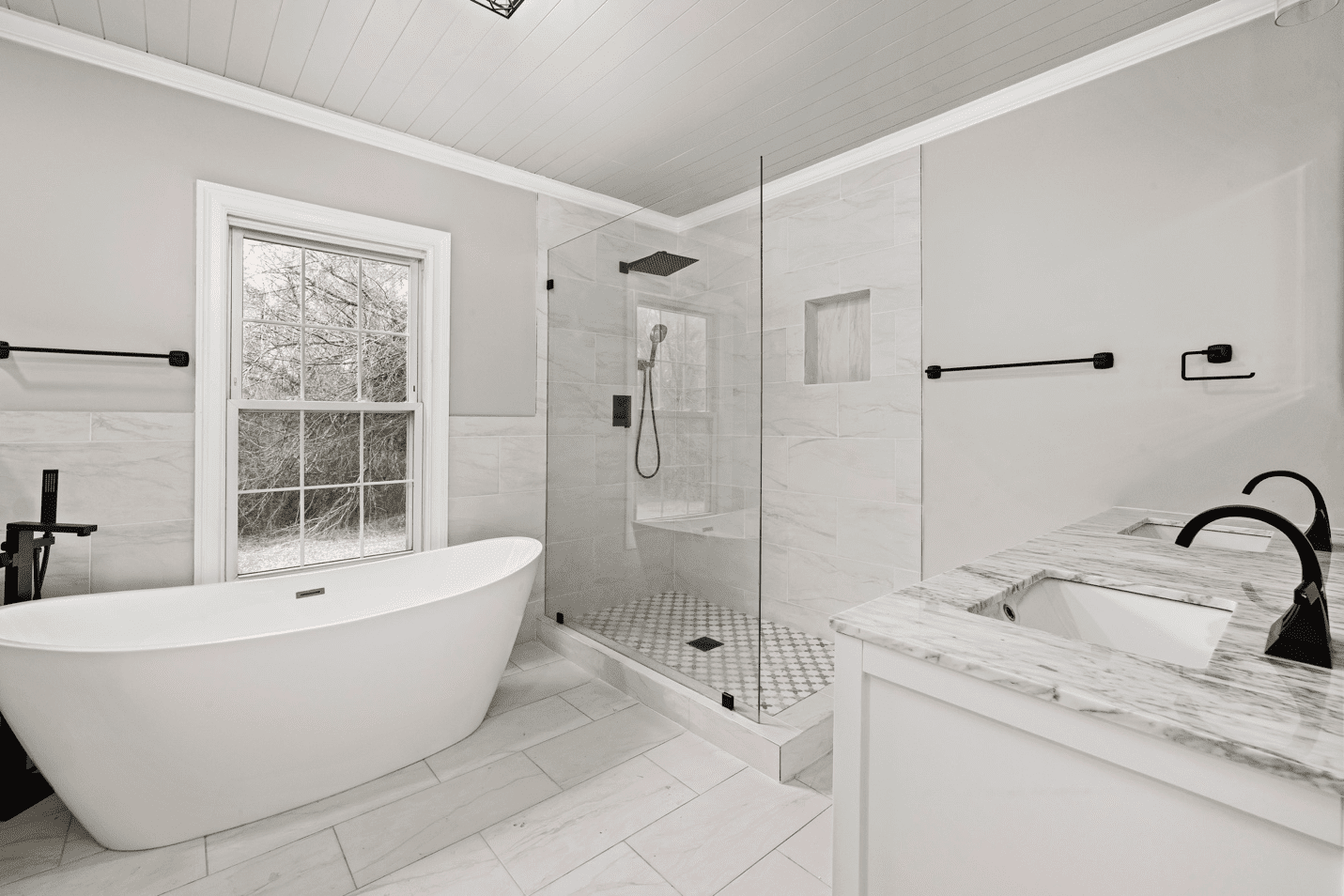 A White Bathroom With Bathtub And Shower Cubicle