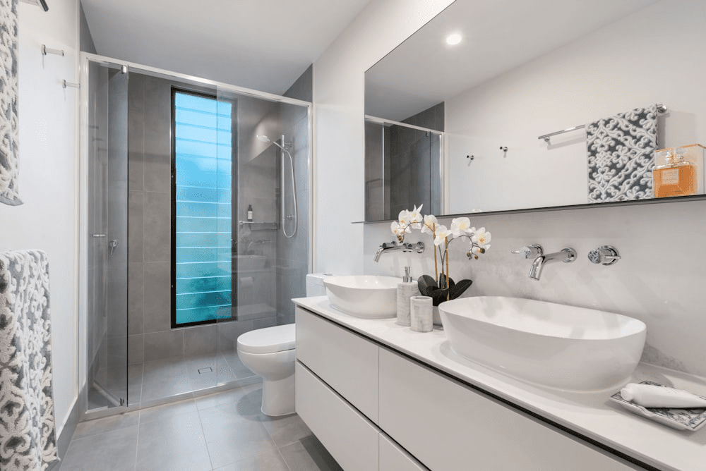 Interior Of A Modern Bathroom With Dual Sinks And A Shower Cubicle