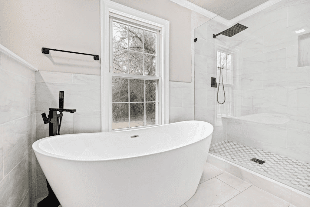 A Modern Bathroom With A Bathtub And Shower Cubicle